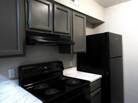 a kitchen with a stove and a refrigerator